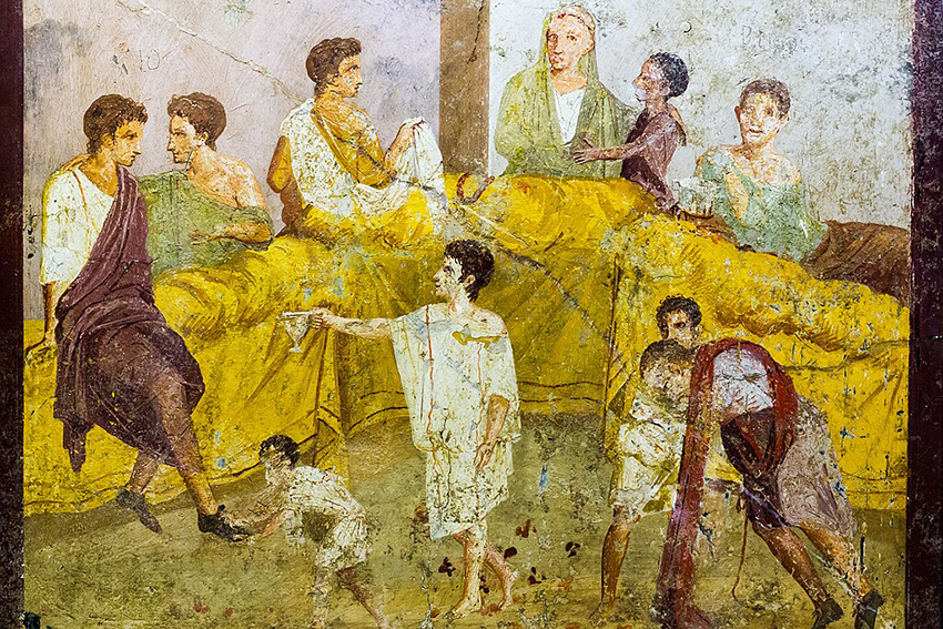 A cracked and faded ancient fresco, depicting a meal scene.