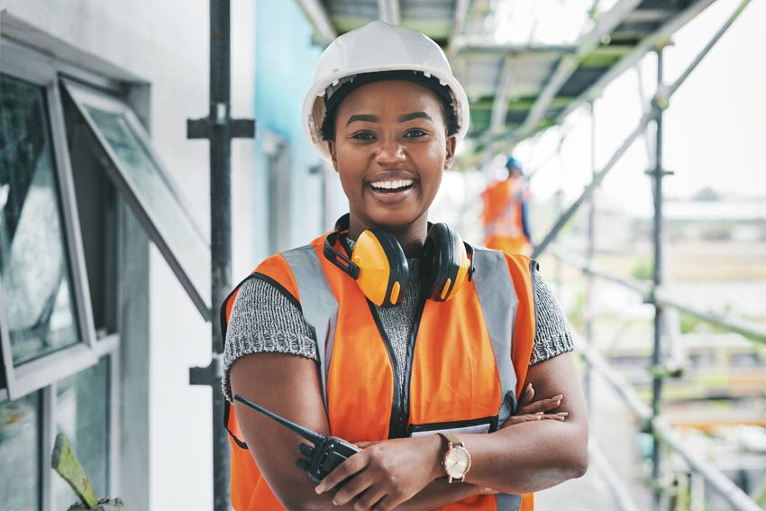 Portrait of a young woman working at a construction site.